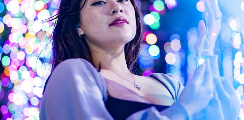 Elegant woman enjoying colorful night lights in Panama City, Panama.