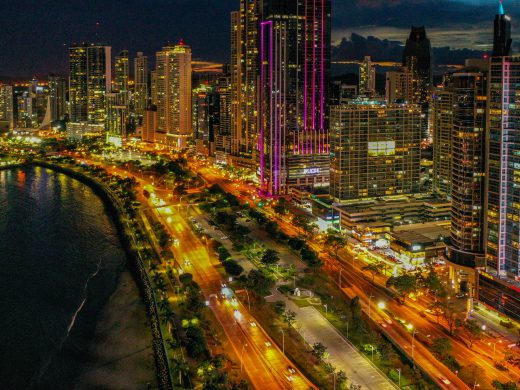 Dazzling aerial view of Panama City's illuminated skyline and waterfront at night.