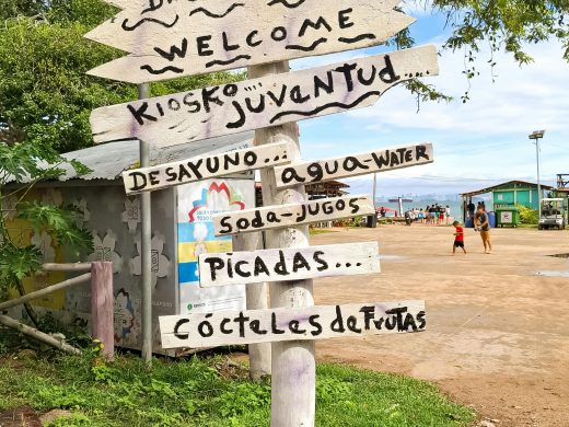 Wooden signpost with food and drink options on Taboga Island, Panama.